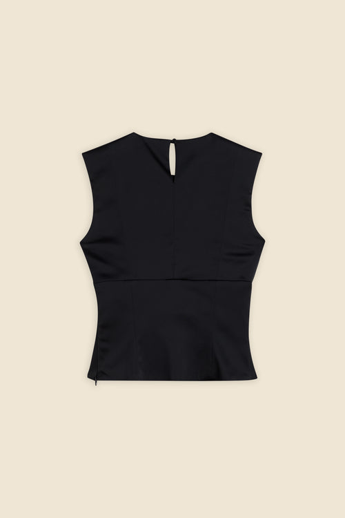 The meticulously placed pleats and stretch satin define the elegance of the top, reflecting classic haute couture craftsmanship with a modern edge