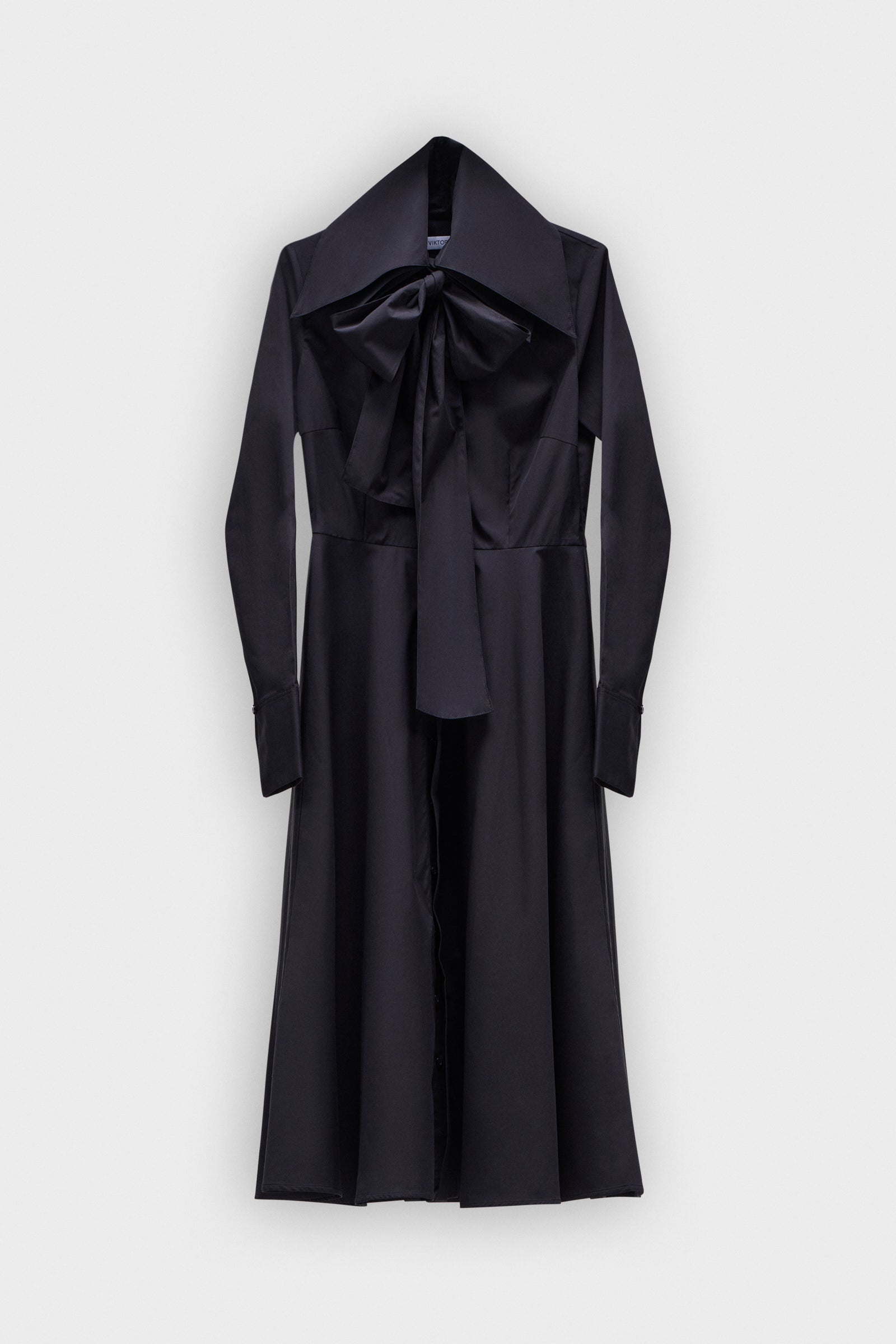 A long black dress with a multi-layer collar and a bow detail on a white background.