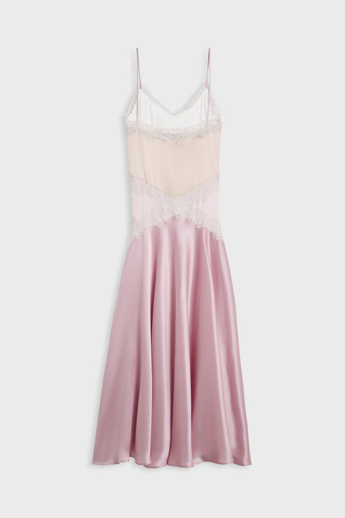 A pink satin slip dress with a light pink lace bodice and white lace trim, shown against a light gray background.
