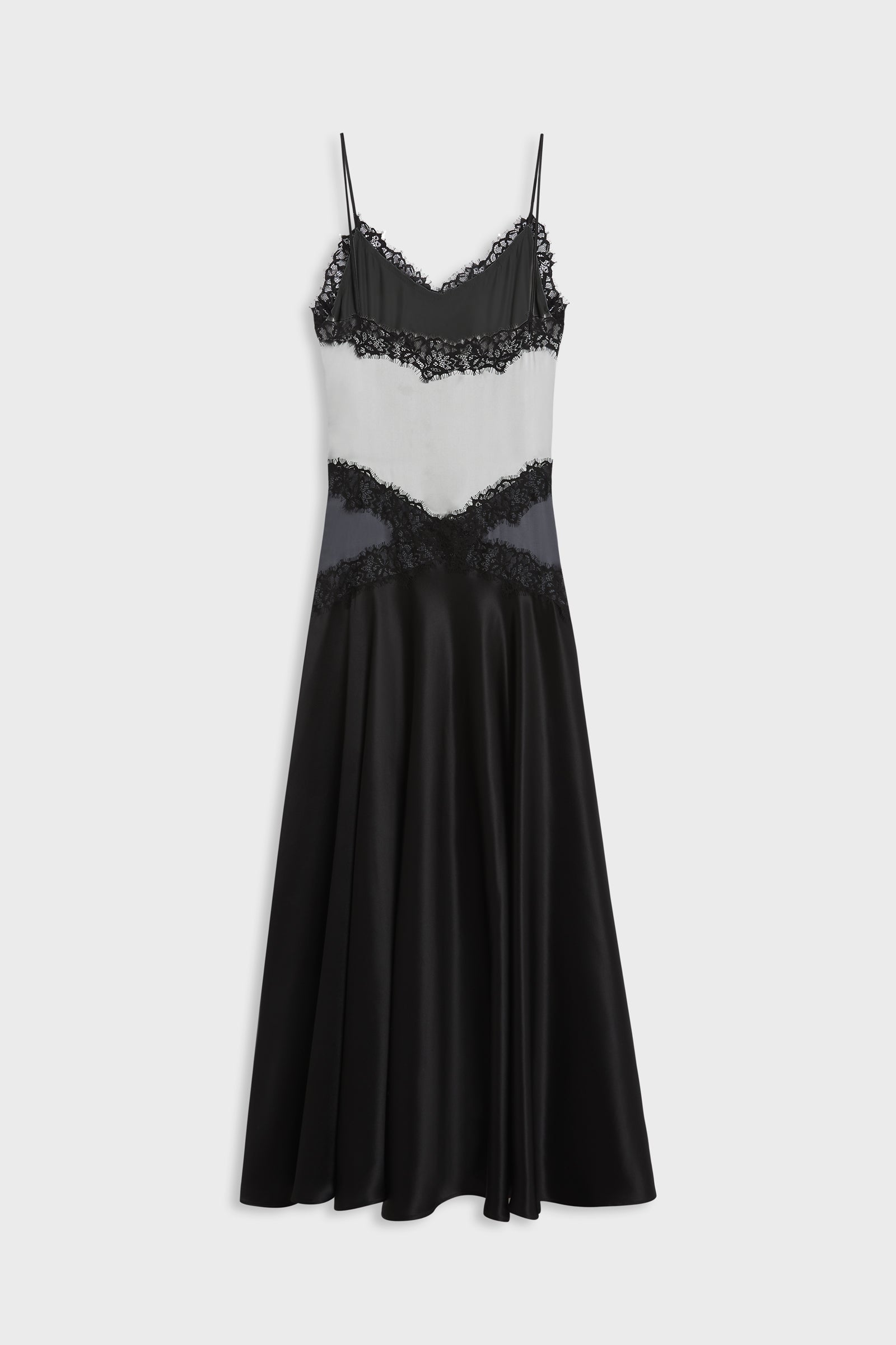 A black and white color-blocked midi slip dress with black lace trim and thin spaghetti straps, shown against a light gray background.