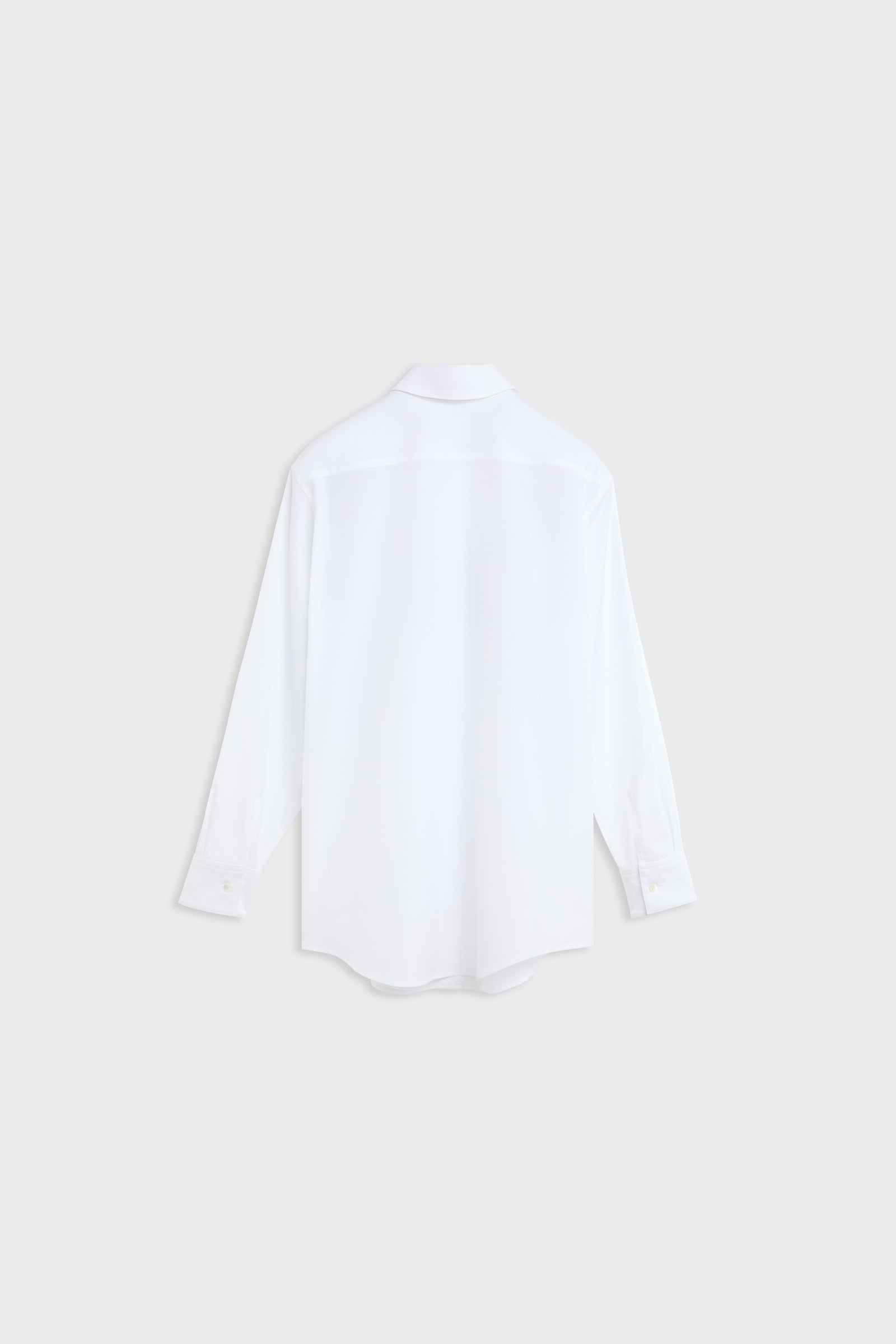 A white long-sleeve button-up shirt shown from the back, photographed flat against a light gray background.