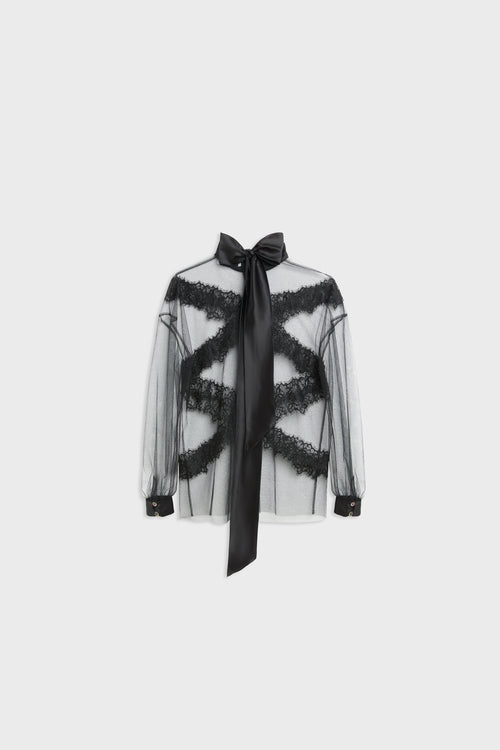 A sheer black long-sleeve blouse with black lace appliques and a matching black necktie bow, displayed on a neutral light gray background.