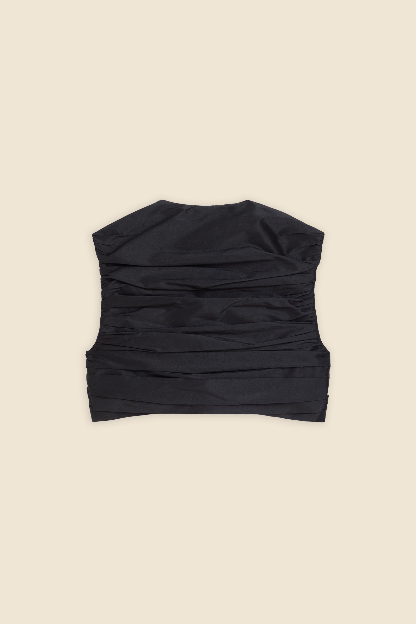 The meticulously placed pleats and silk-blend taffeta define the elegance of the top, reflecting classic haute couture craftsmanship with a modern edge