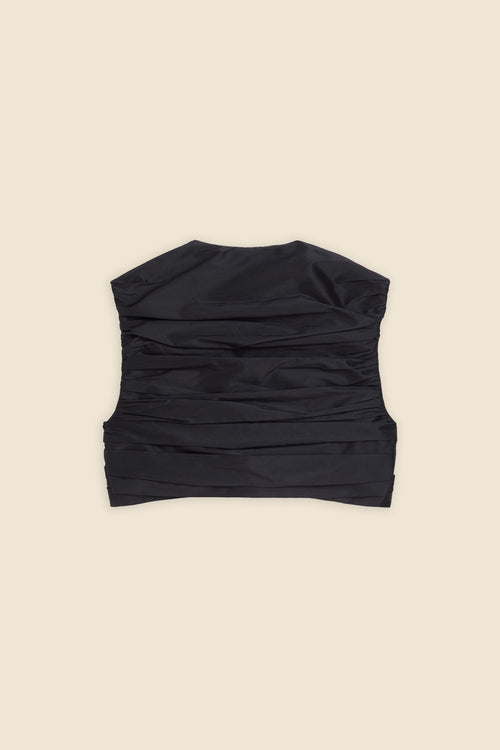 The meticulously placed pleats and silk-blend taffeta define the elegance of the top, reflecting classic haute couture craftsmanship with a modern edge