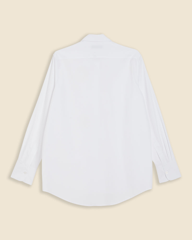 Crisp white cotton shirt with long sleeves, featuring a classic straight back design and buttoned cuffs against a beige background.