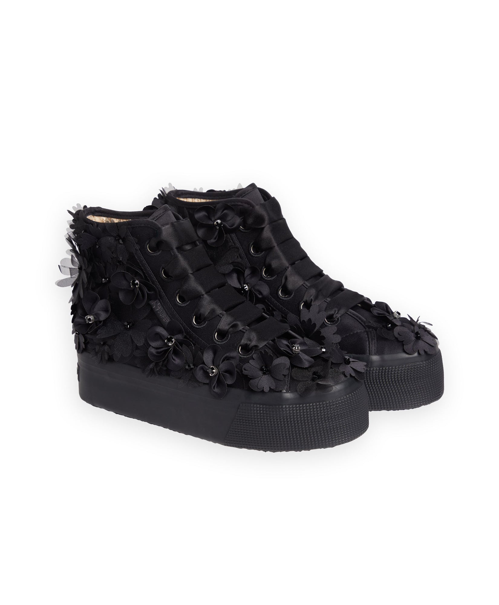 Black platform sneakers adorned with floral appliqués, featuring intricate black 3D flower designs and satin ribbon details.