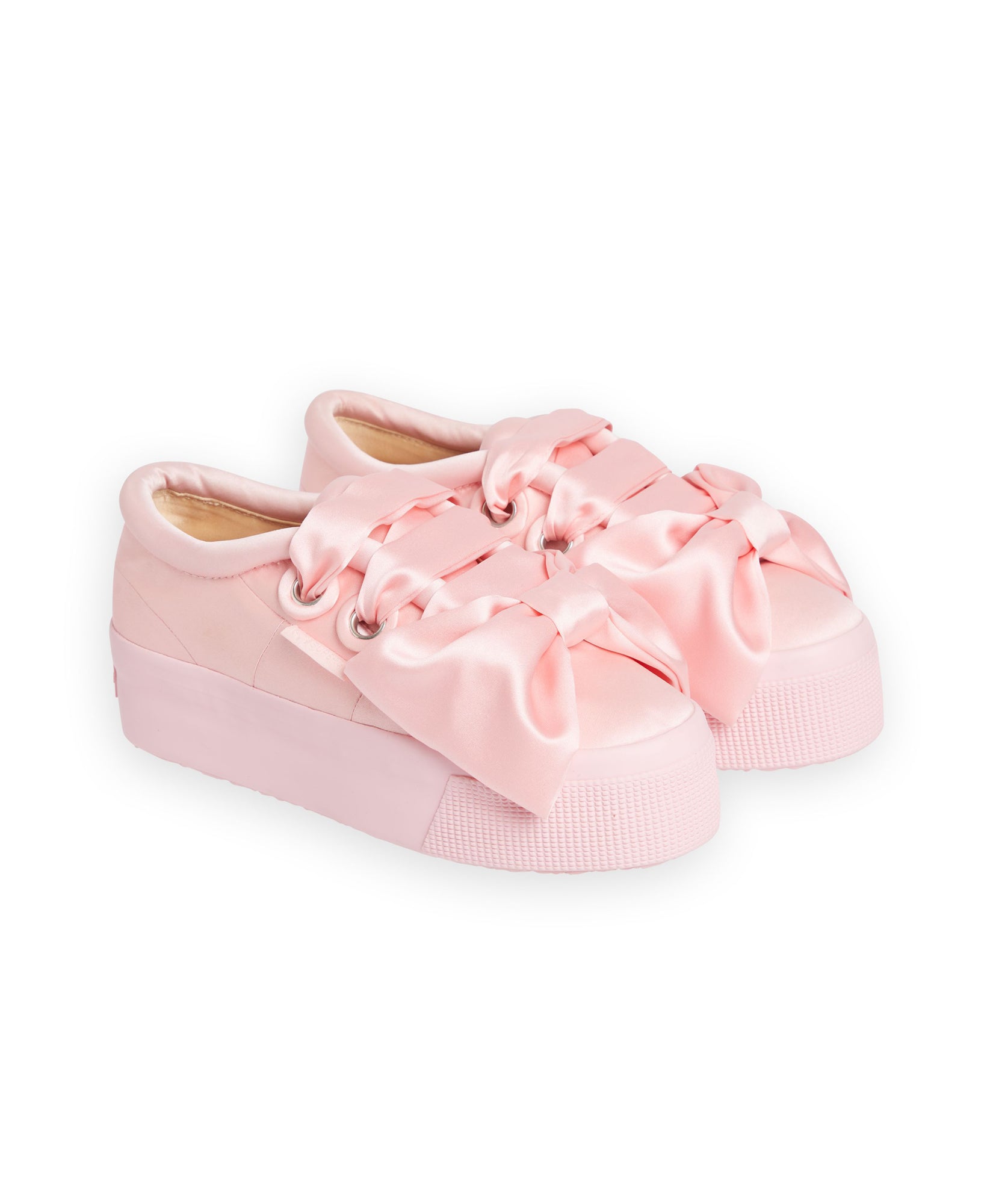 Pink satin sneakers adorned with oversized bows, featuring a chunky platform sole for a stylish and playful look.