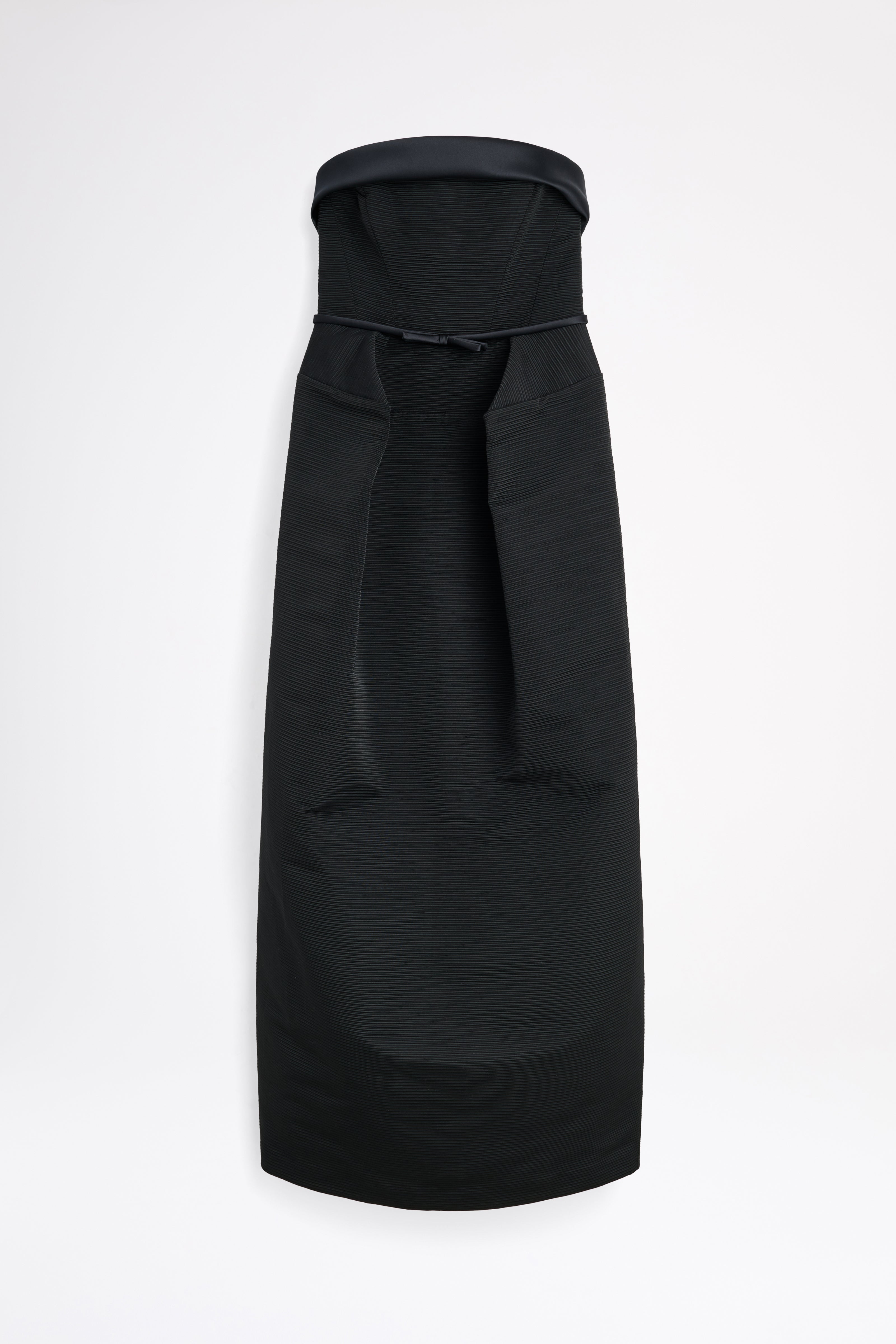 Black dress with a bow detail on a white background