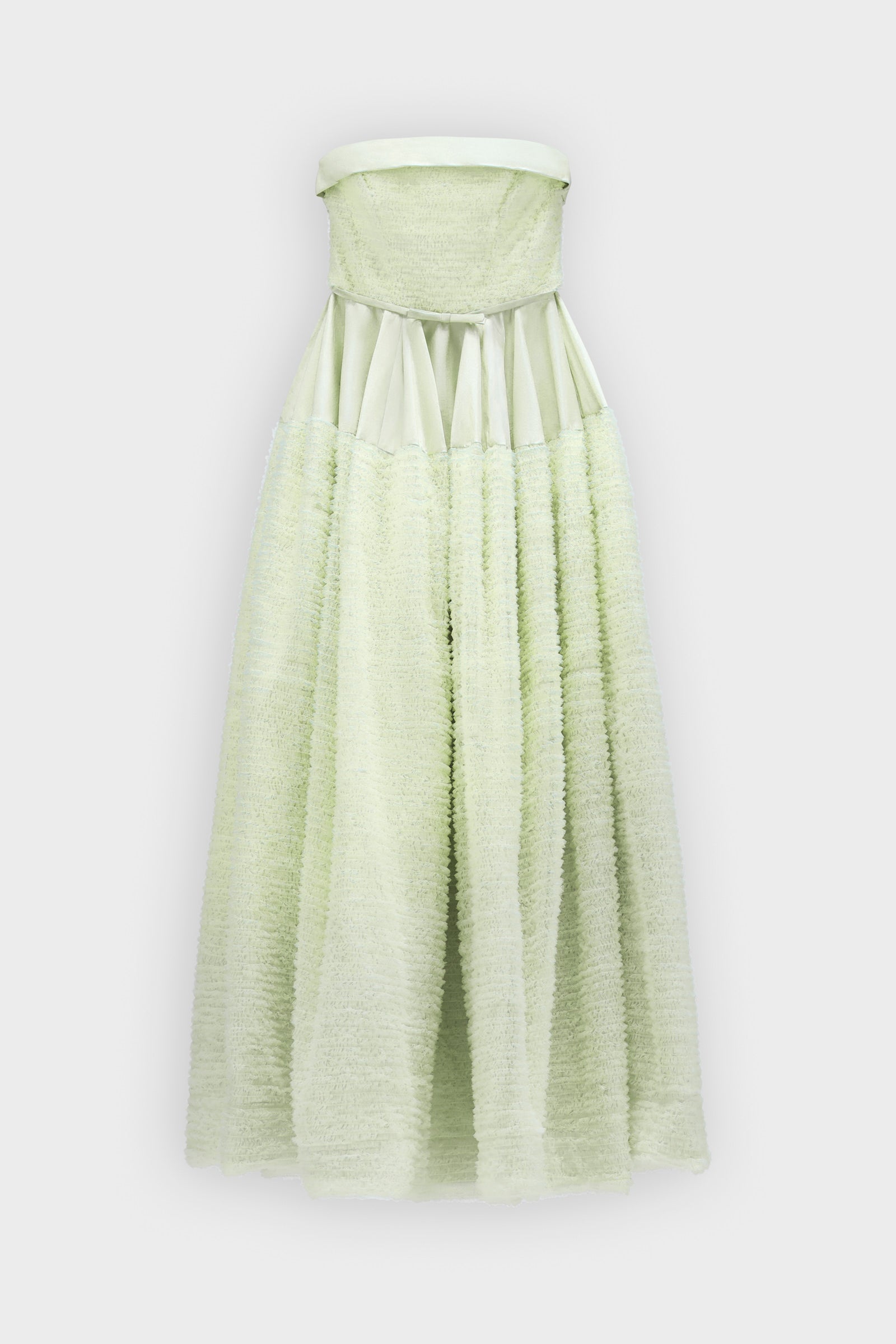 A mint green strapless tulle gown on a white background.