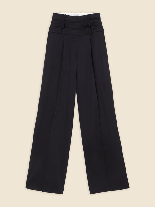 The haute couture "power dressing" inspired multilayered trouser defines utilitarian elegance, seamlessly blending feminine and masculine aesthetics through its tailored silhouette