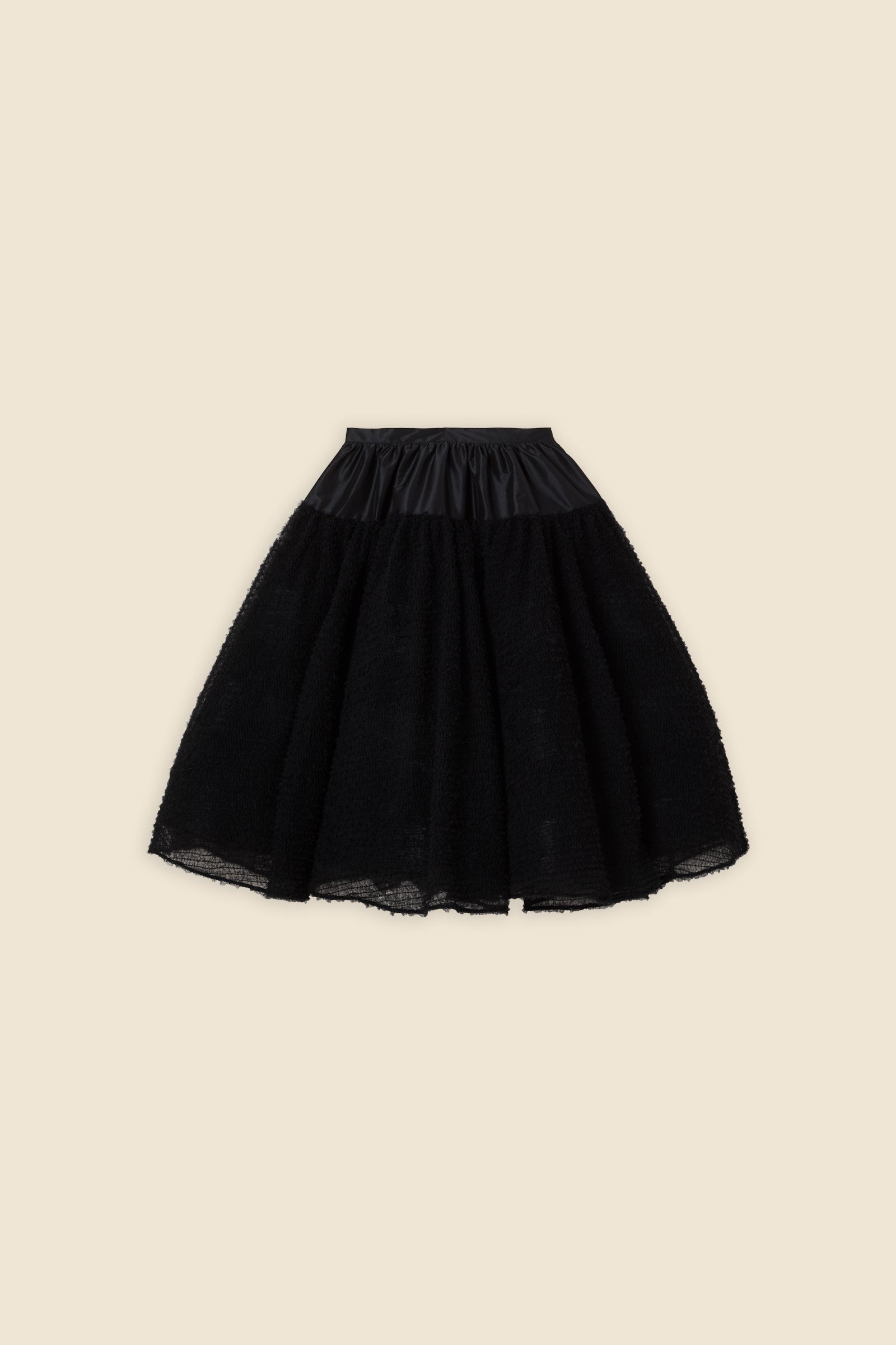 Inspired by the tulle from the ‘late stage capitalism waltz’ haute couture collection, the skirt features hand crafted tulle ruffles for a feminine texture
