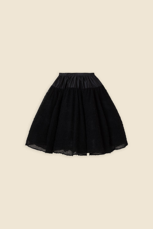 Inspired by the tulle from the ‘late stage capitalism waltz’ haute couture collection, the skirt features hand crafted tulle ruffles for a feminine texture