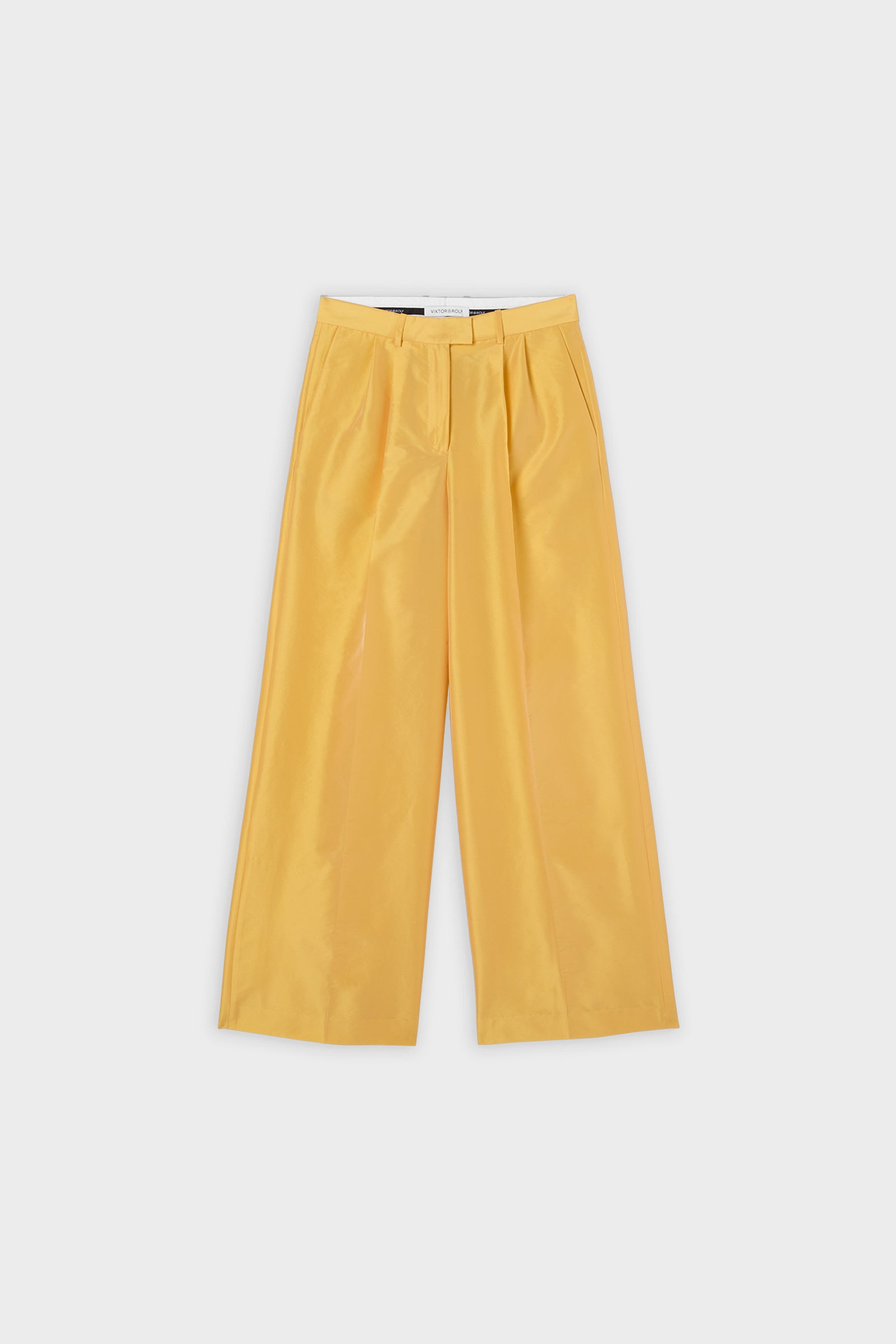 Yellow satin pants on a white background.