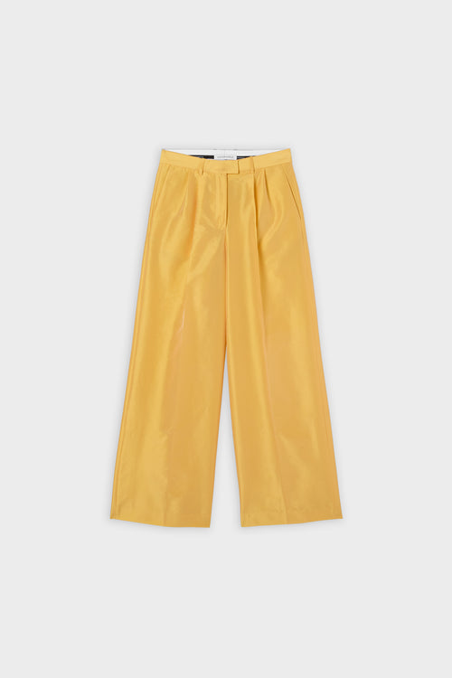 Yellow satin pants on a white background.