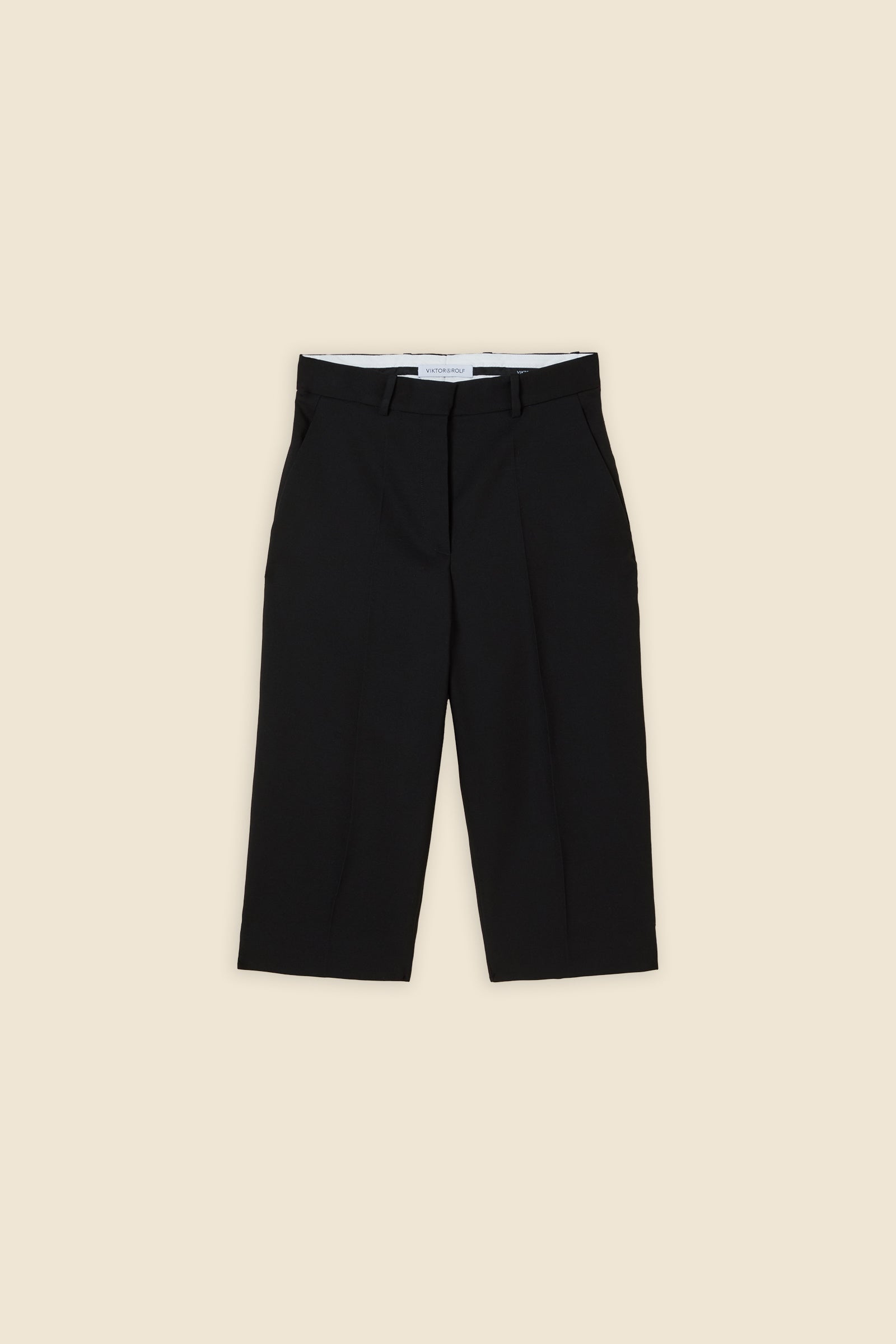 Crafted from wool, the high-waisted capri pant offers a tailored fit and timeless elegance