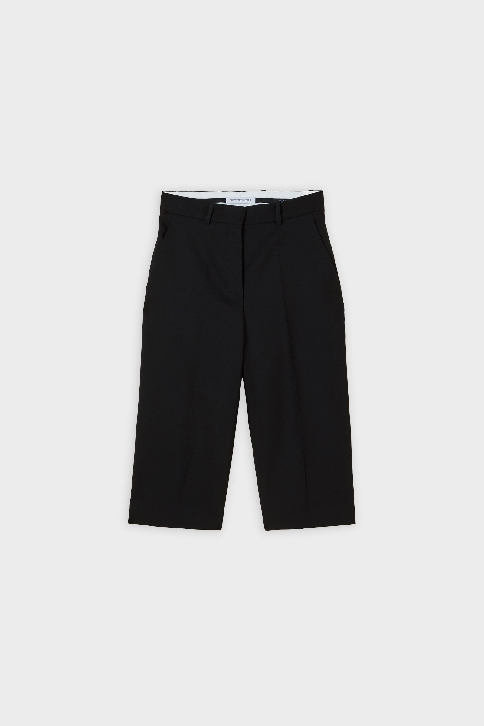 Black capri pants on a white background.
