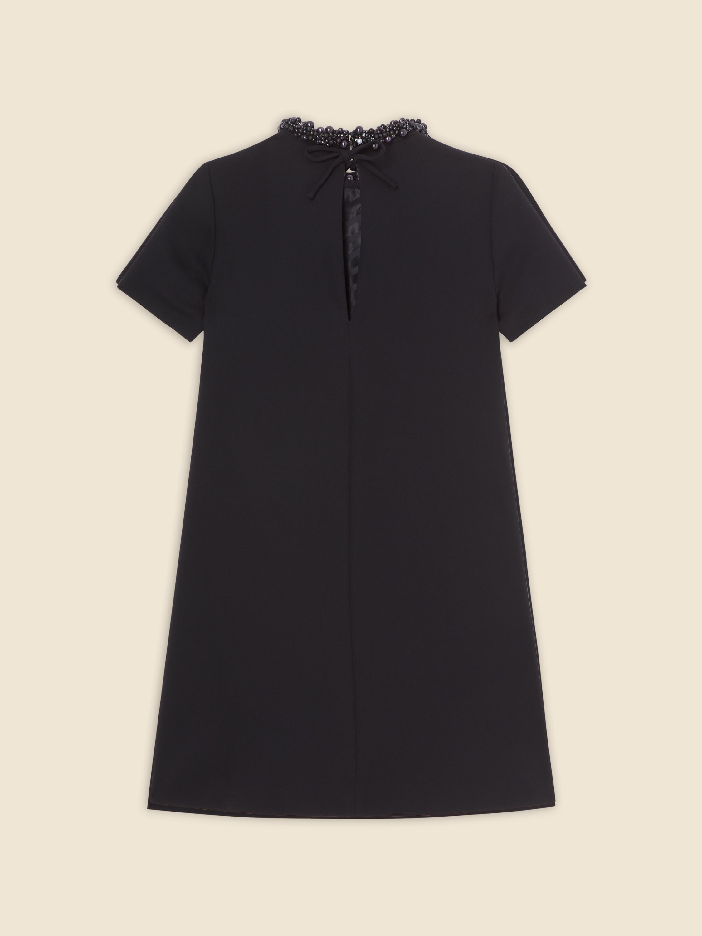 Black A-line dress with short sleeves and a round neckline, adorned with intricate black bead embellishments around the collar.