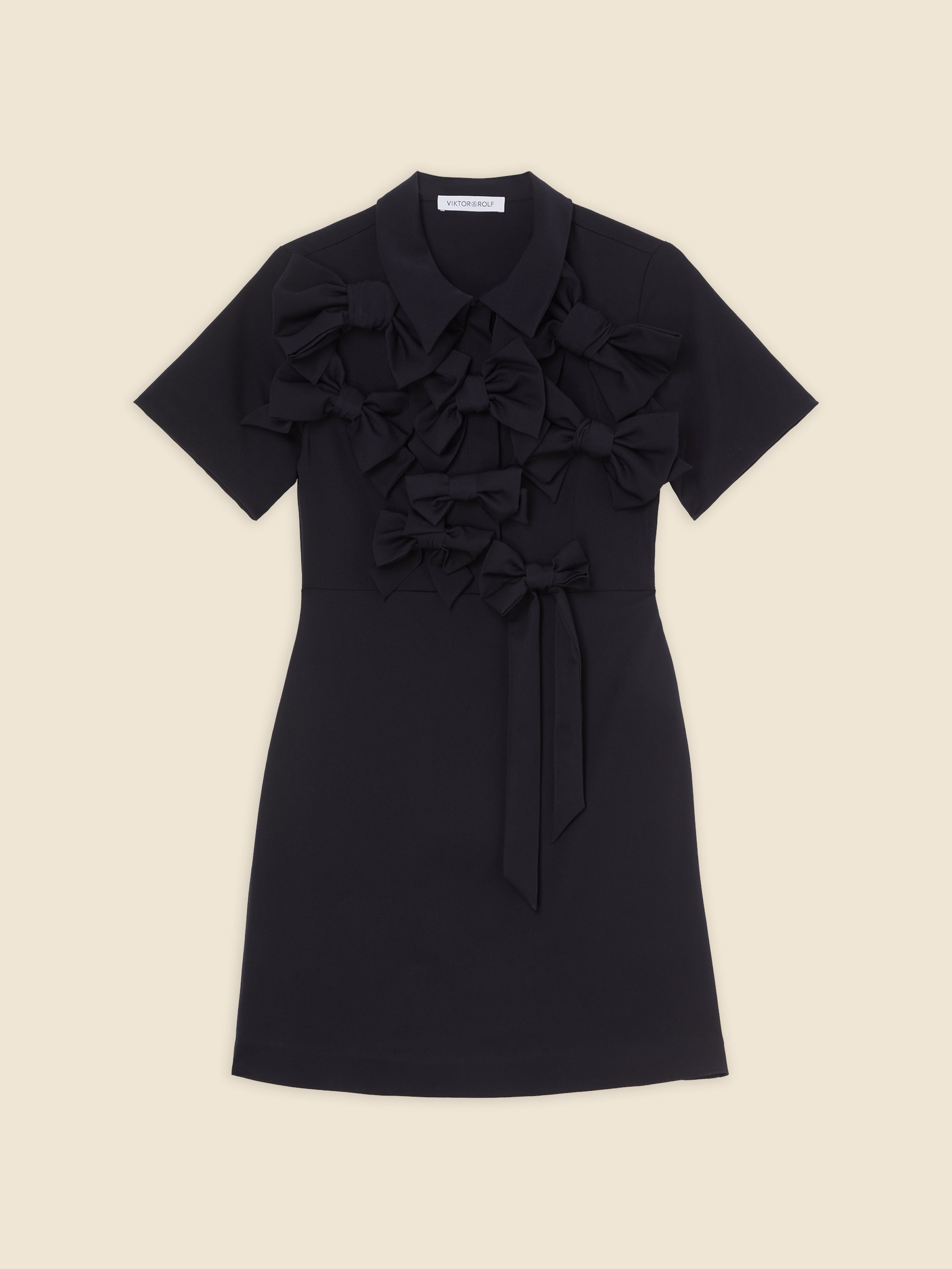 Black short-sleeve dress with multiple decorative bows on the front, featuring a collar and a sash tie waist.