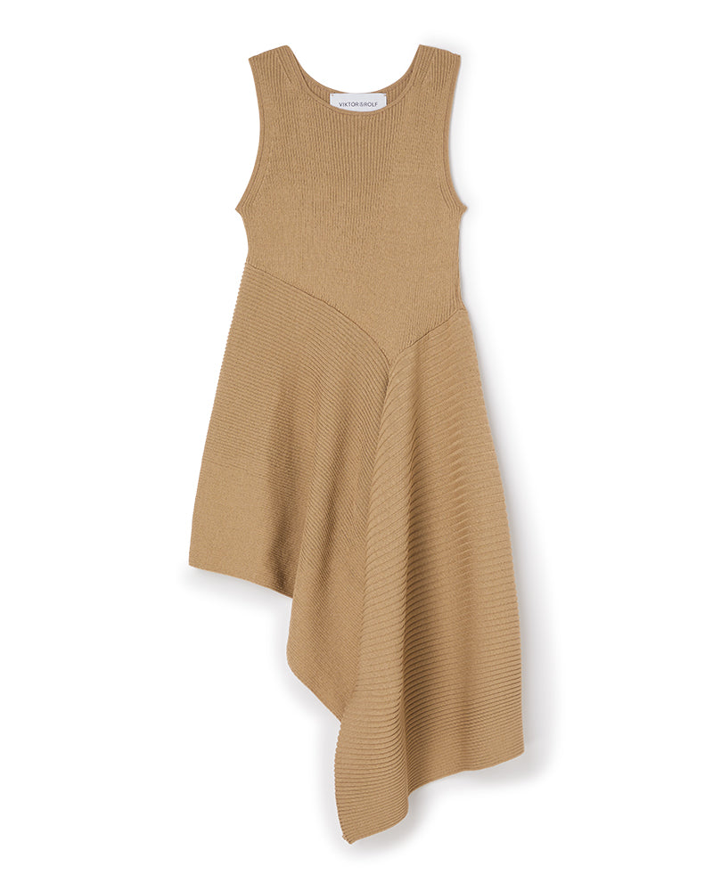Asymmetrical sleeveless knit dress in a warm beige hue, featuring ribbed texture and a flowing diagonal hemline.