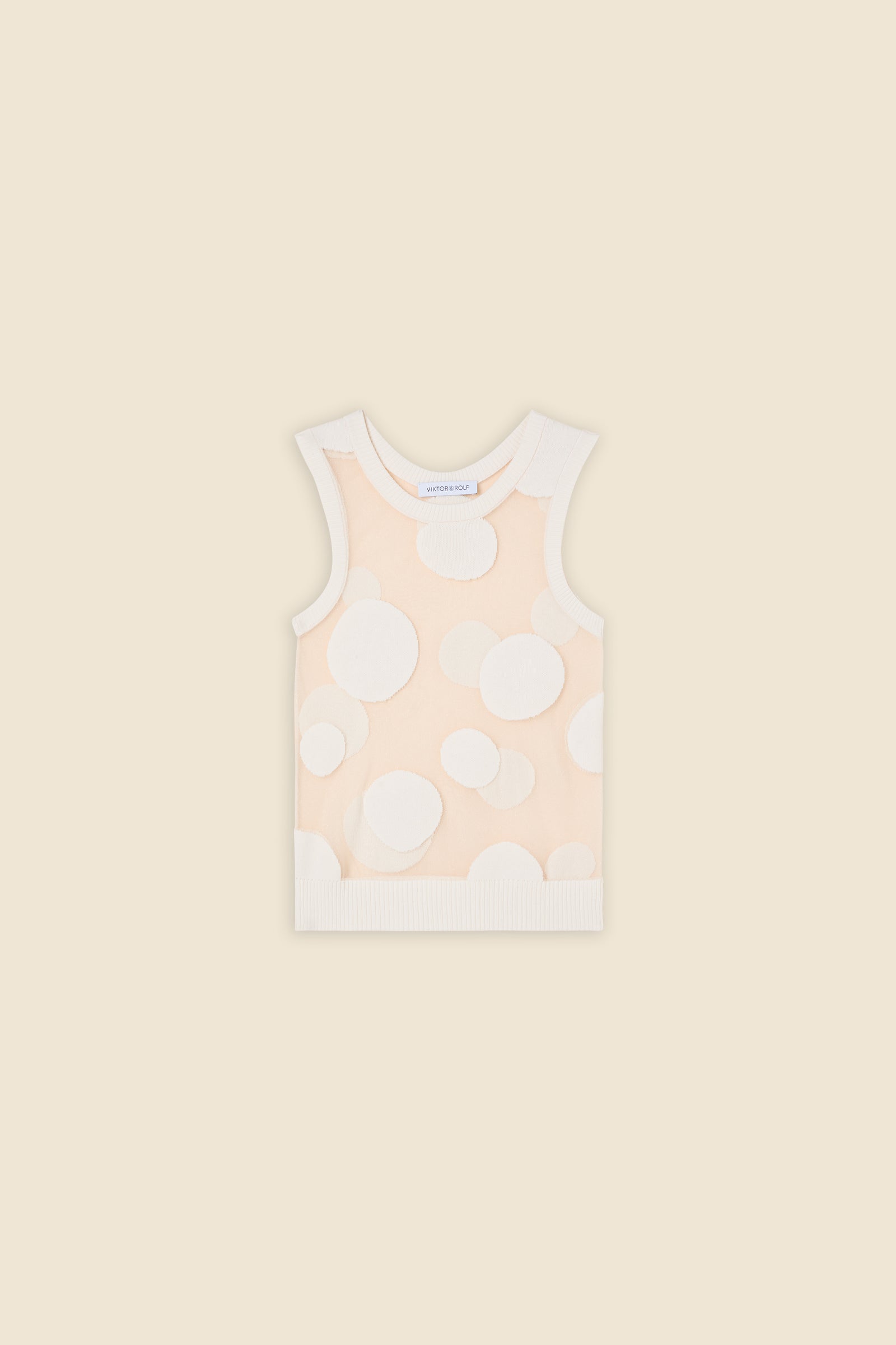 The classic pattern of the top is given a modern twist with intricate polka dot hole design on knit jacquard