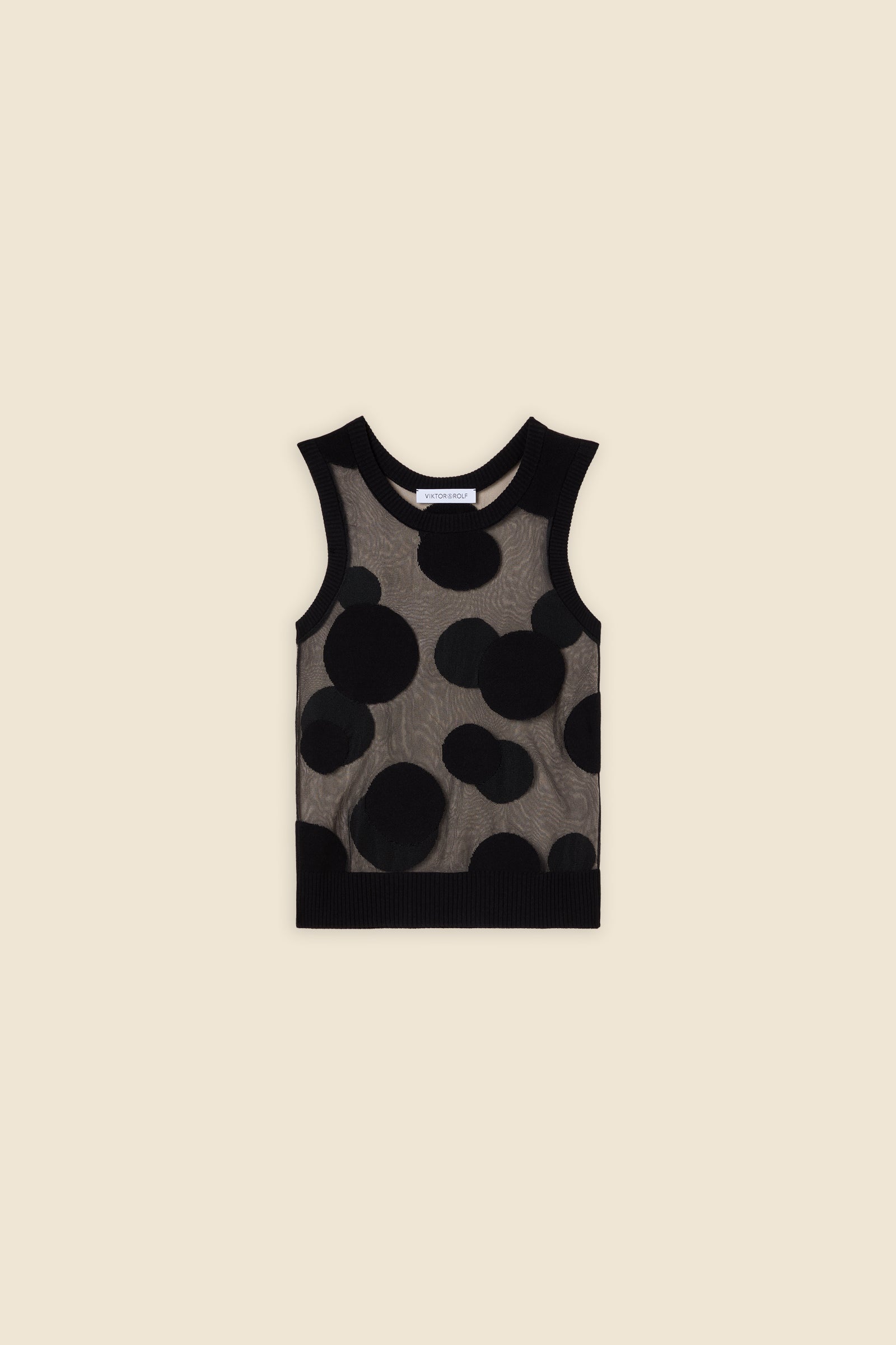 The classic pattern of the top is given a modern twist with intricate polka dot hole design on knit jacquard