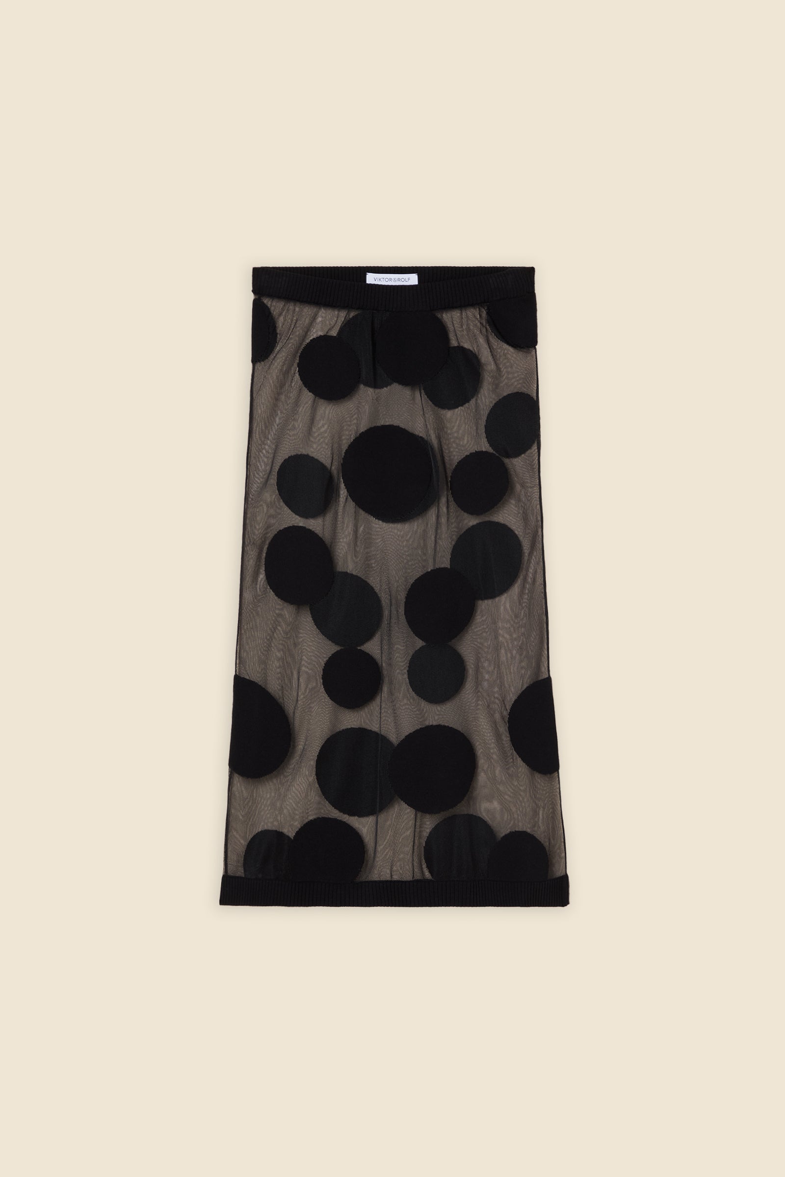 The classic pattern of the skirt is given a modern twist with intricate polka dot hole design on knit jacquard