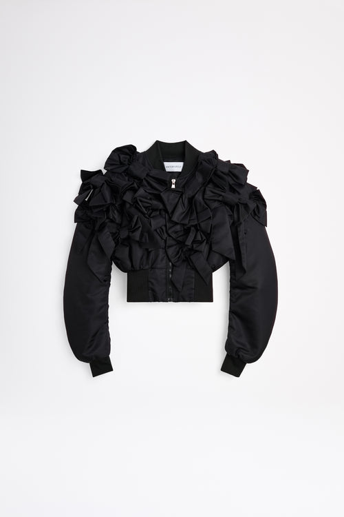 The bomber inspired by the haute couture "action dolls" collection reinvents playful sophistication, merging the volume of a puffer design with a seasonal bow bouquet technique
