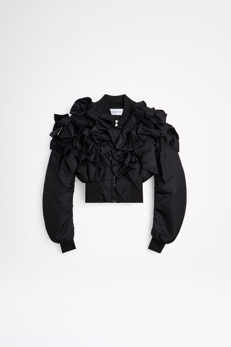 The bomber inspired by the haute couture "action dolls" collection reinvents playful sophistication, merging the volume of a puffer design with a seasonal bow bouquet technique