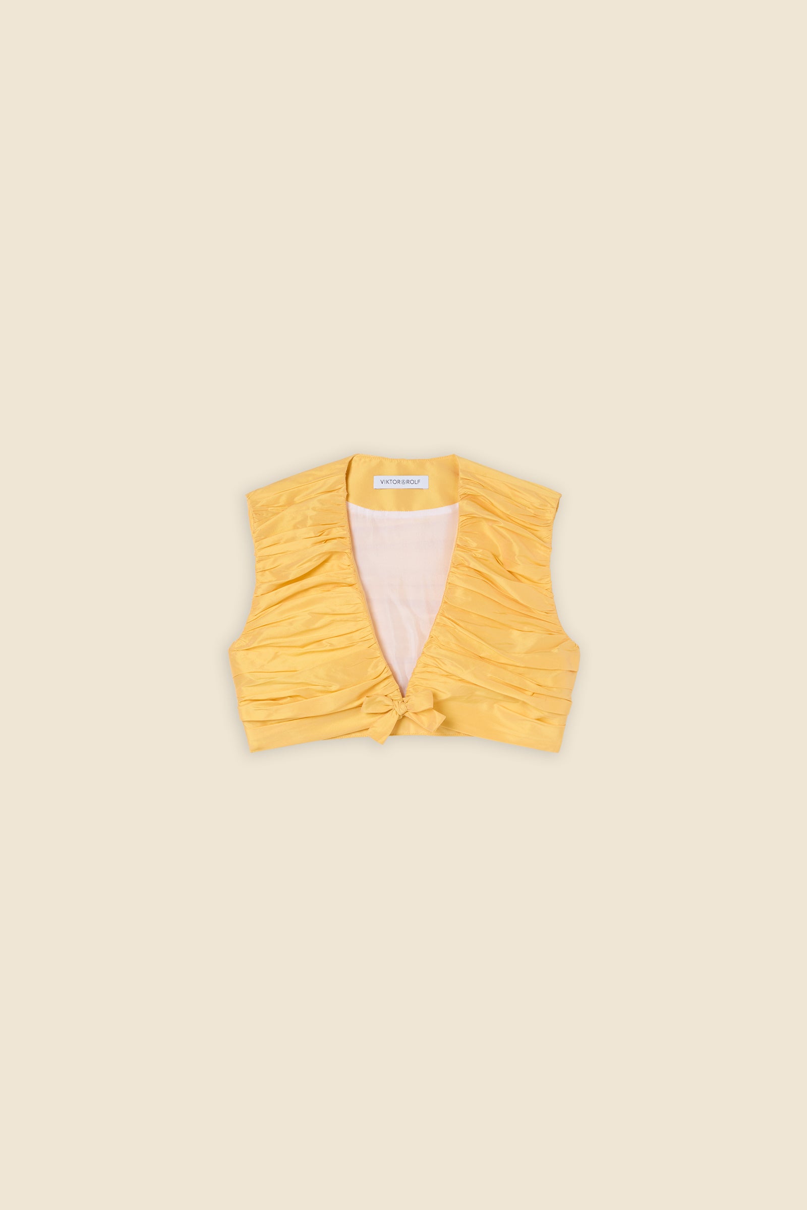 The meticulously placed pleats and silk-blend taffeta define the elegance of the top, reflecting classic haute couture craftsmanship with a modern edge