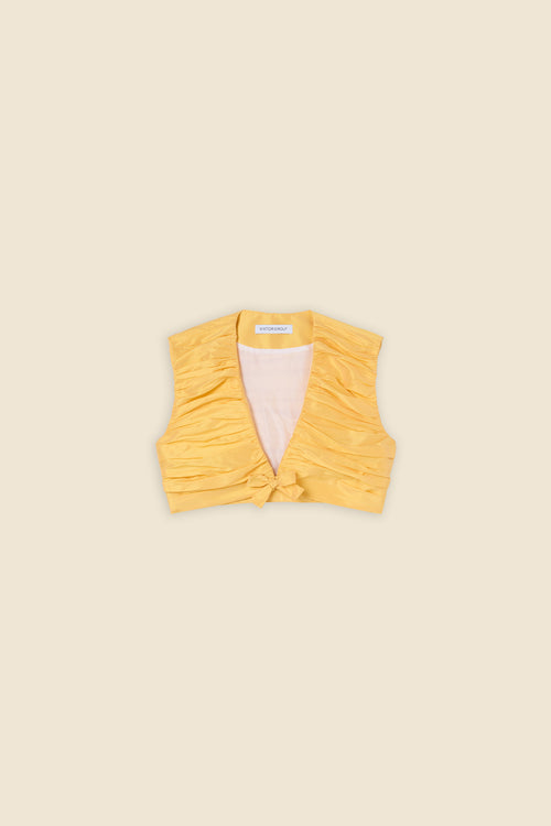The meticulously placed pleats and silk-blend taffeta define the elegance of the top, reflecting classic haute couture craftsmanship with a modern edge