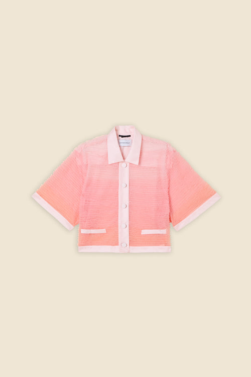 Inspired by the tulle from the ‘late stage capitalism waltz’ haute couture collection, the shirt features hand crafted tulle ruffles for a feminine texture