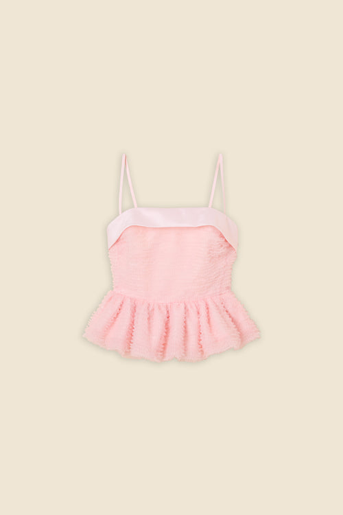 Inspired by the tulle from the ‘late stage capitalism waltz’ haute couture collection, the top features hand crafted tulle ruffles for a feminine texture