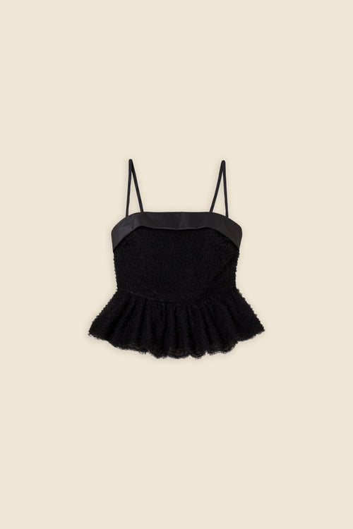 Inspired by the tulle from the ‘late stage capitalism waltz’ haute couture collection, the top features hand crafted tulle ruffles for a feminine texture