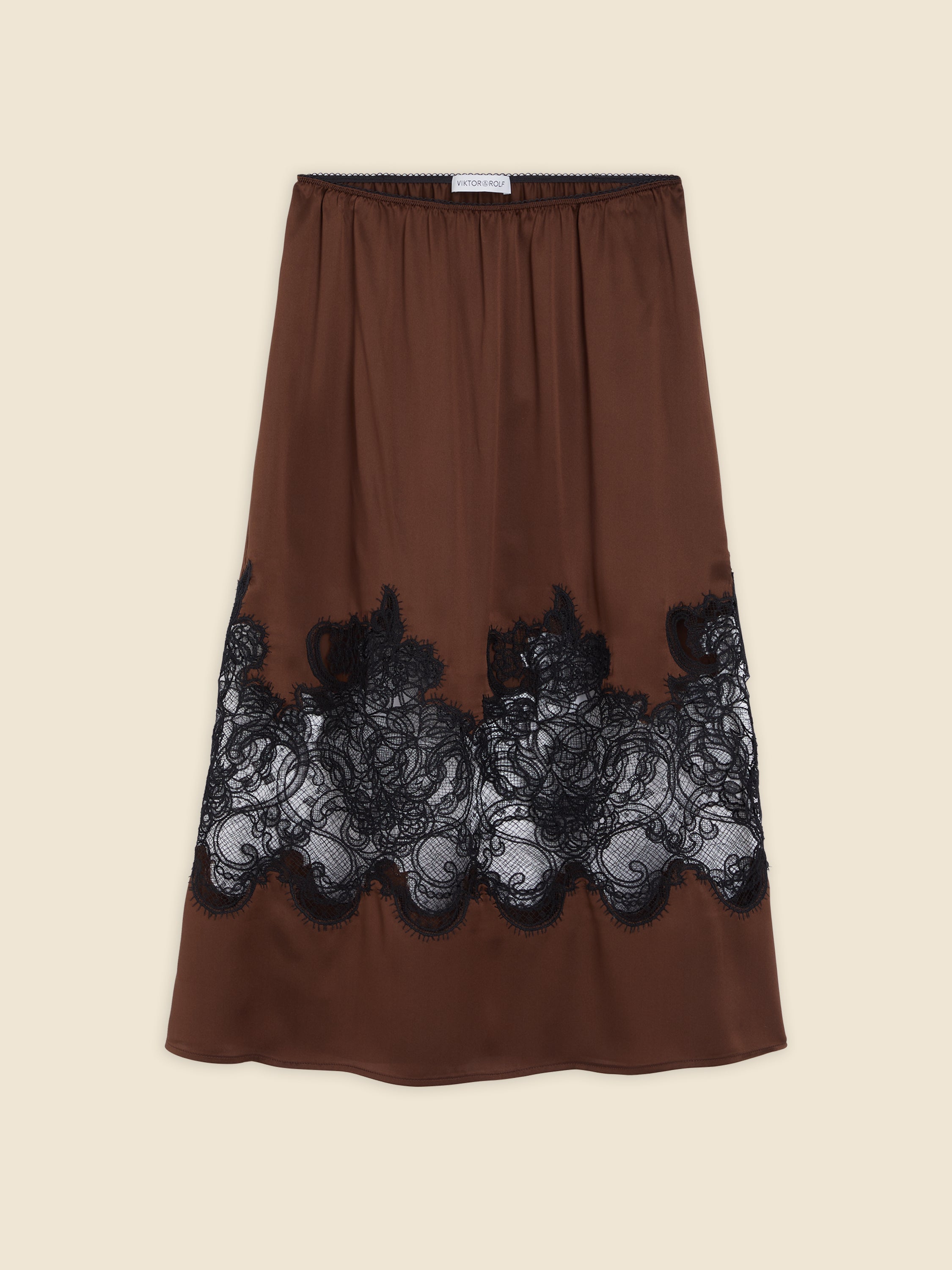 Elegant brown silk slip skirt with intricate black lace detailing, creating a sophisticated and luxurious look.
