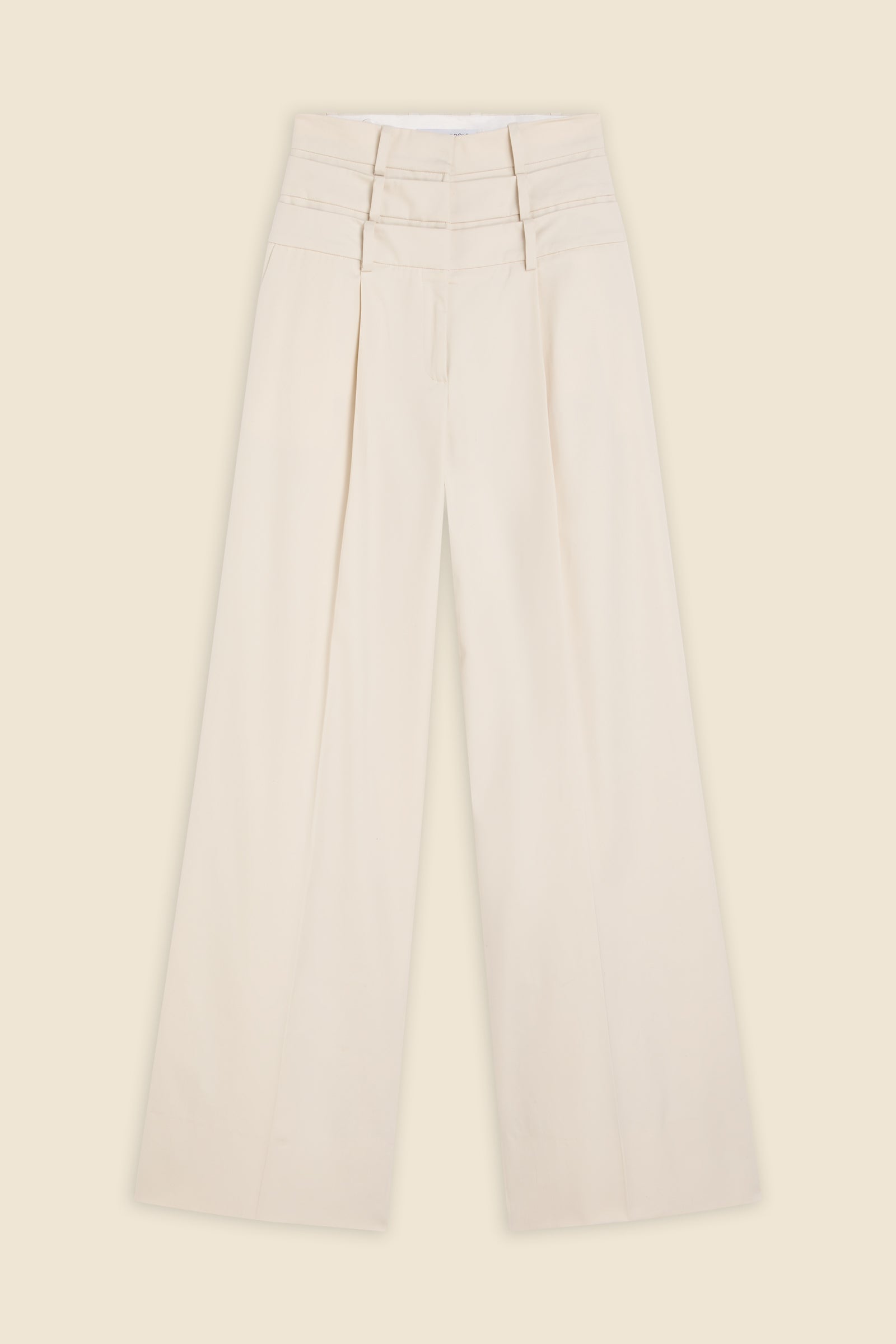 Beige multi-layer high waist trousers on a beige background.