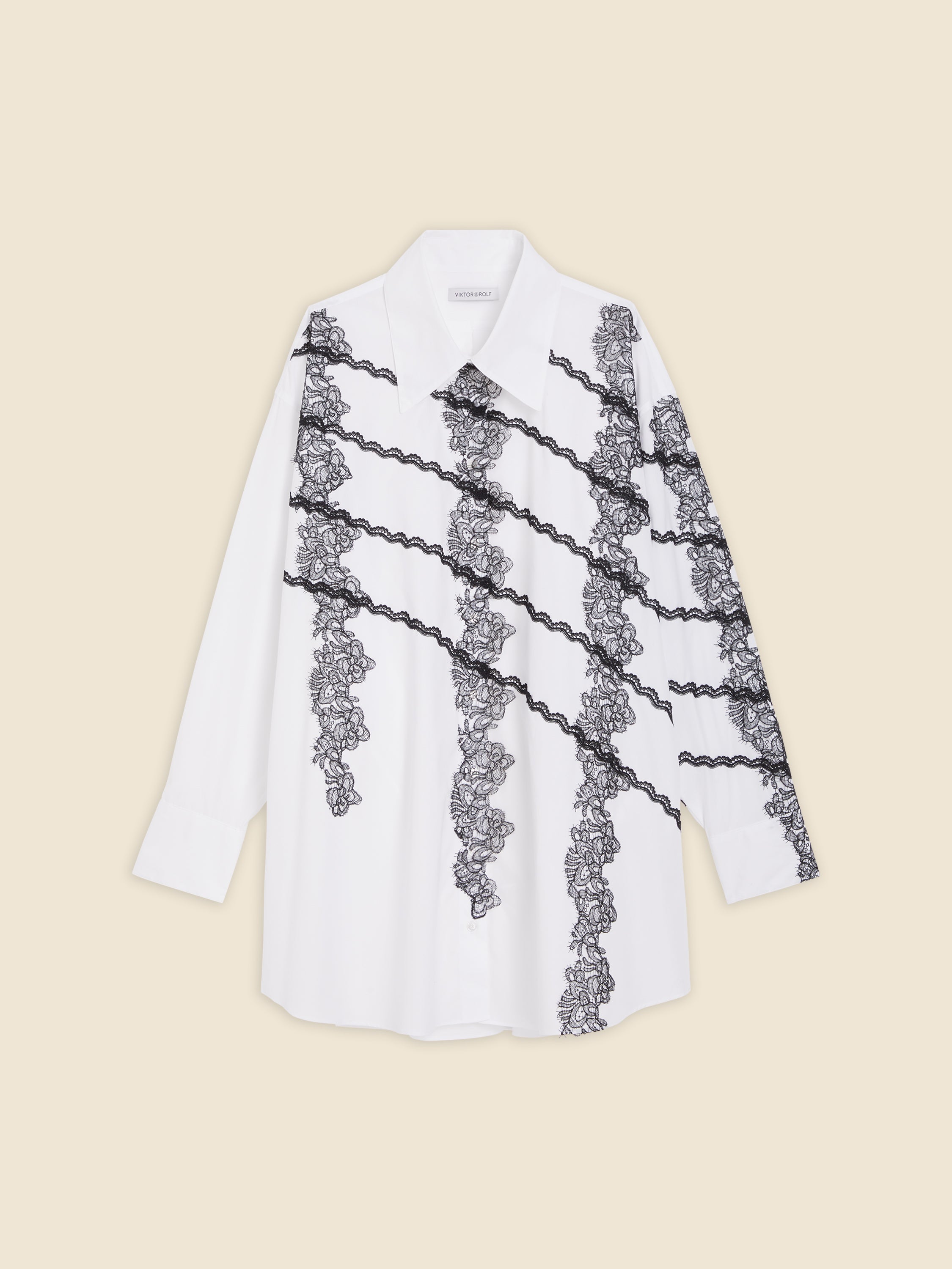 Elegant white shirt featuring diagonal black lace floral embroidery, tailored with a classic collar and structured cuffs.