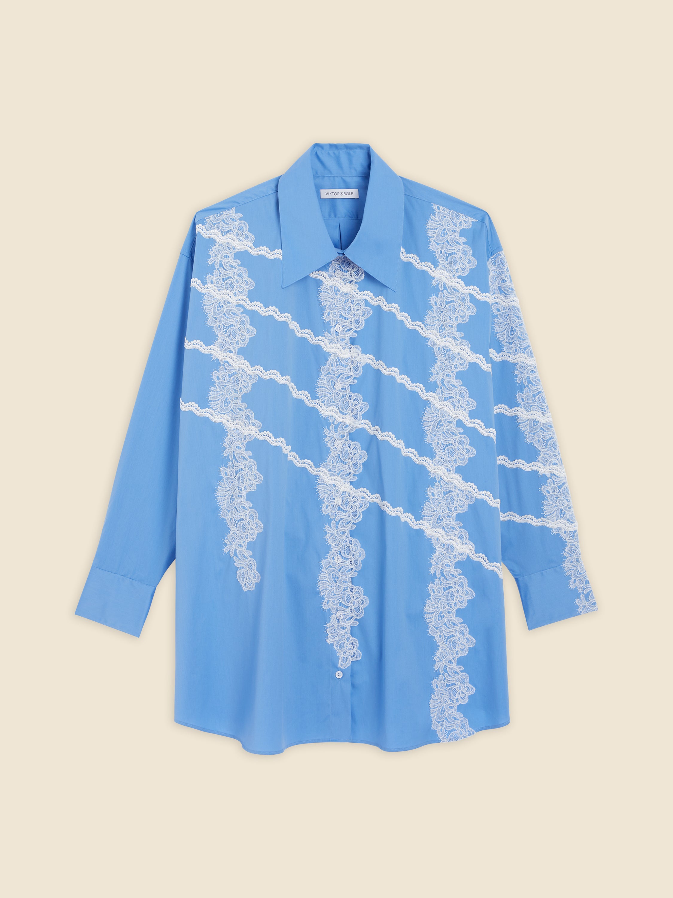 Light blue shirt with intricate white lace details diagonally across the front, featuring a classic pointed collar and button closure.
