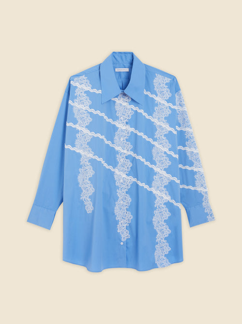 Light blue shirt with intricate white lace details diagonally across the front, featuring a classic pointed collar and button closure.