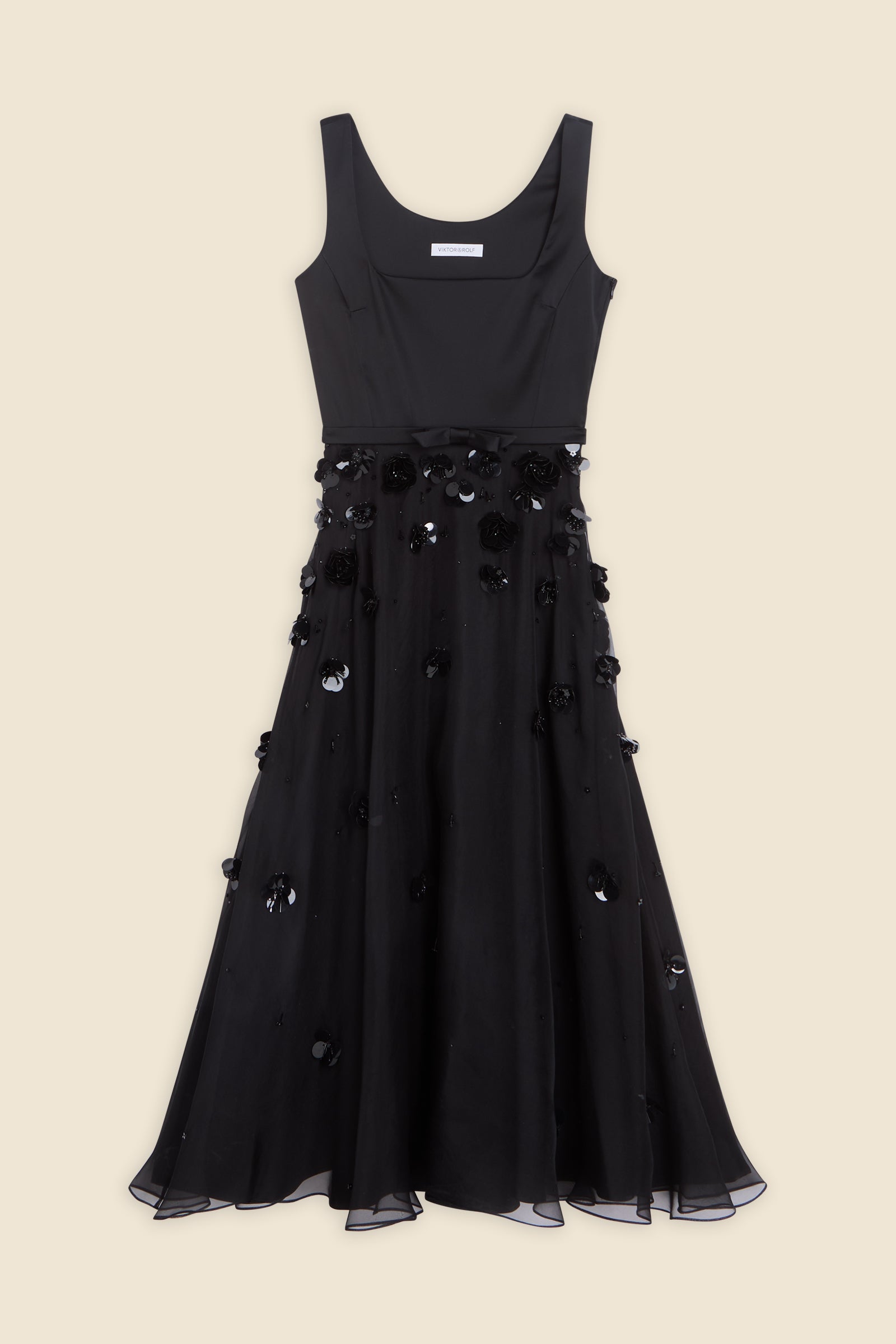 With hand-applied paillettes and crystals on silk organza featuring the satin edges, the dress transforms classic floral embroidery into a modern piece