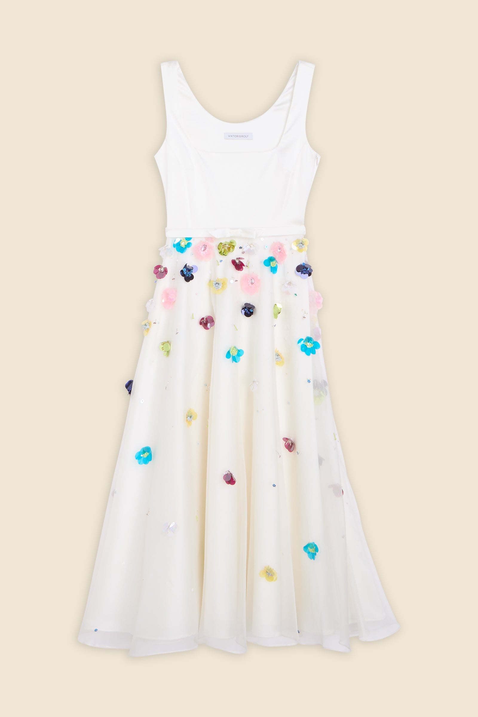 With hand-applied paillettes and crystals on silk organza featuring the satin edges, the dress transforms classic floral embroidery into a modern piece
