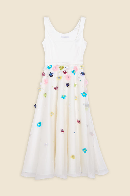 With hand-applied paillettes and crystals on silk organza featuring the satin edges, the dress transforms classic floral embroidery into a modern piece