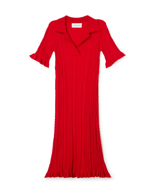 Red knitted dress featuring wavy textured pattern and flared sleeves, with a classic collar and flowing silhouette.