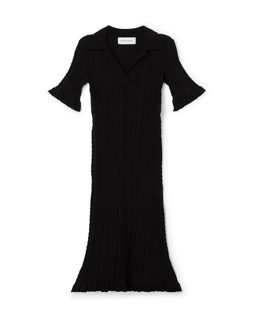 Elegant black ribbed knit dress with flared sleeves and collar, featuring intricate textured patterns for stylish sophistication.