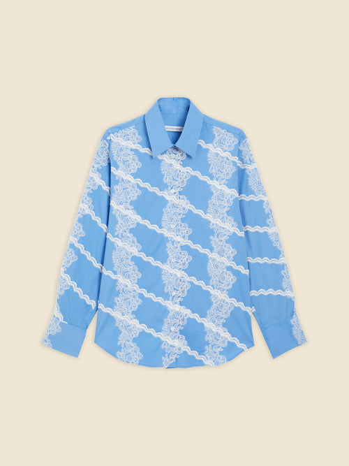 A sky-blue shirt featuring elegant white lace diagonal stripes, providing a chic contrast and delicate floral pattern.