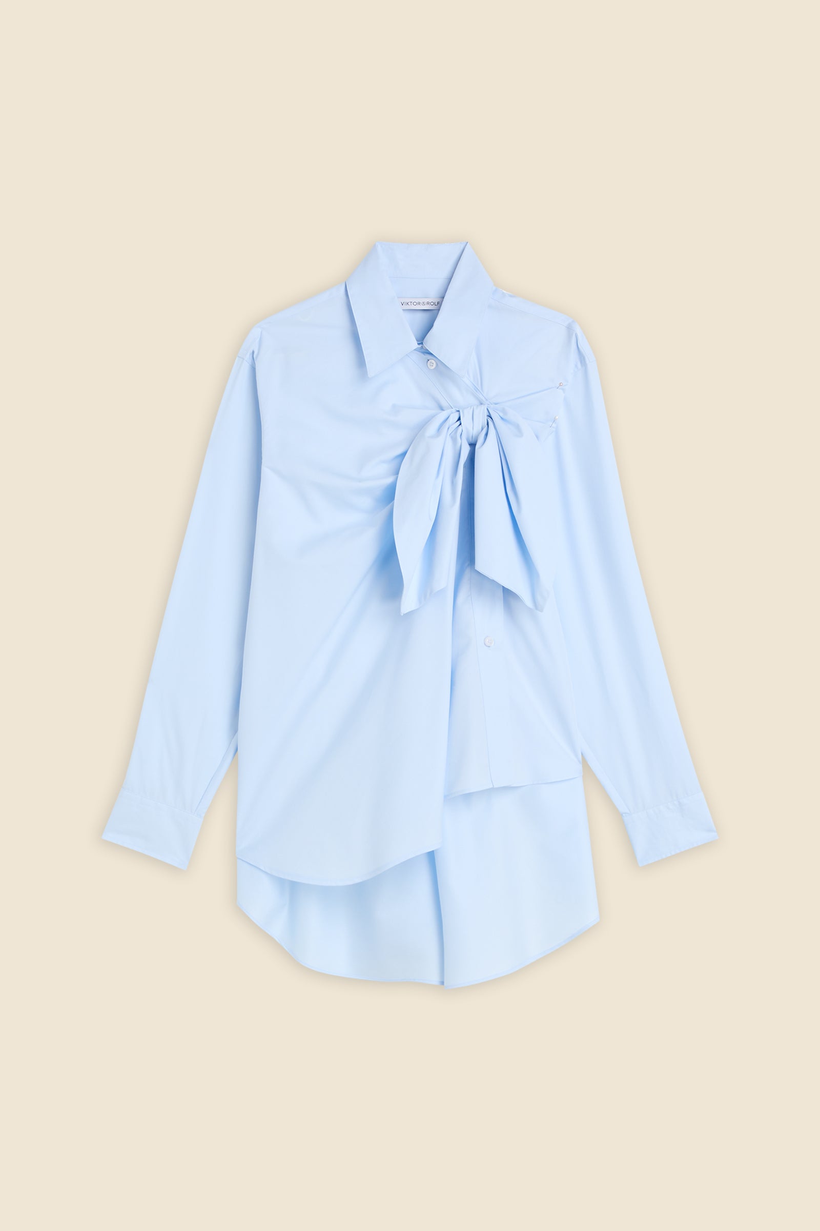 Drawing from viktor&rolf’s haute couture ‘red carpet’ collection, the shirt transforms traditional menswear patterns into a feminine, glamorous silhouette