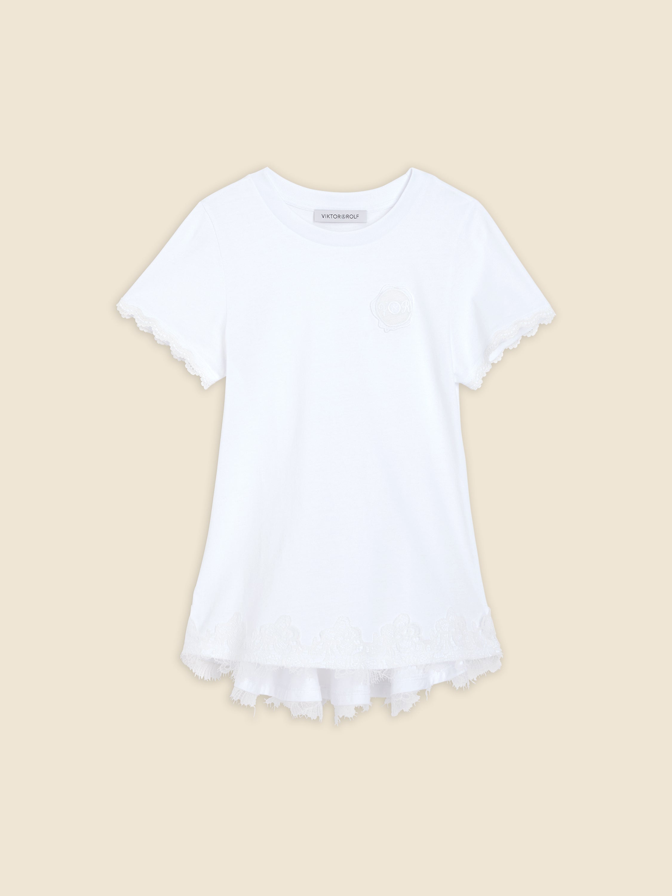 White cotton T-shirt with intricate lace edges on sleeves and hem, featuring elegant tonal embroidery detail.
