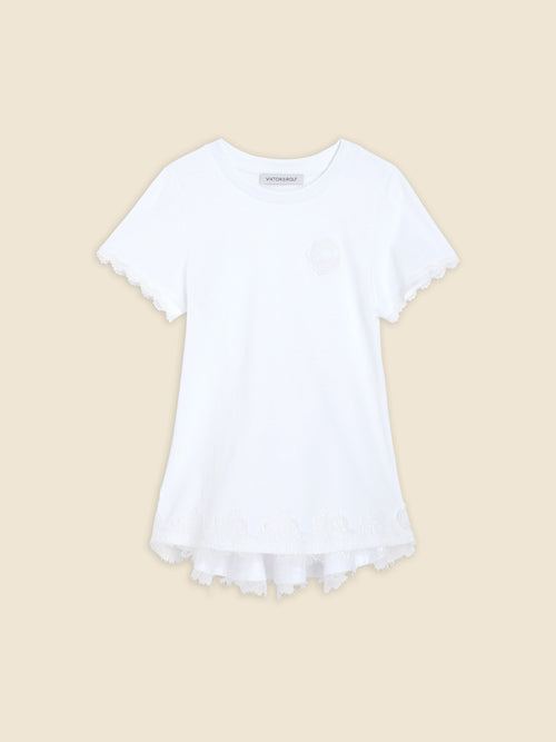 White cotton T-shirt with intricate lace edges on sleeves and hem, featuring elegant tonal embroidery detail.