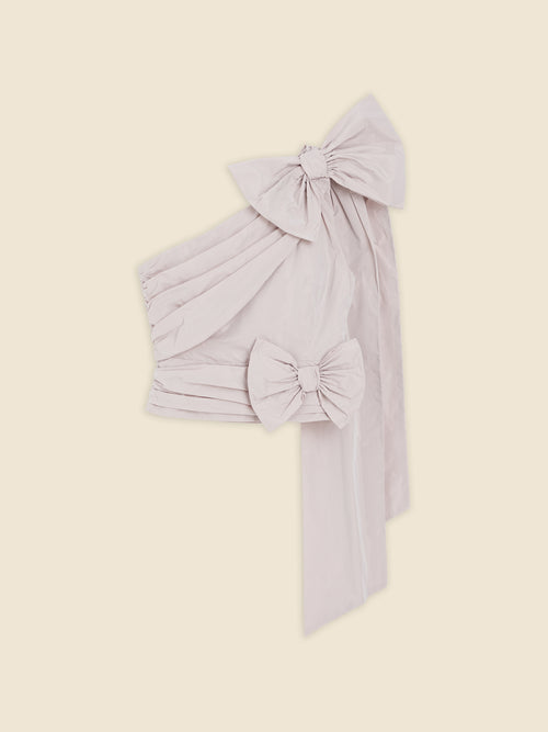 Elegant pale pink fabric with large decorative bows, creating a sophisticated and luxurious design focus.