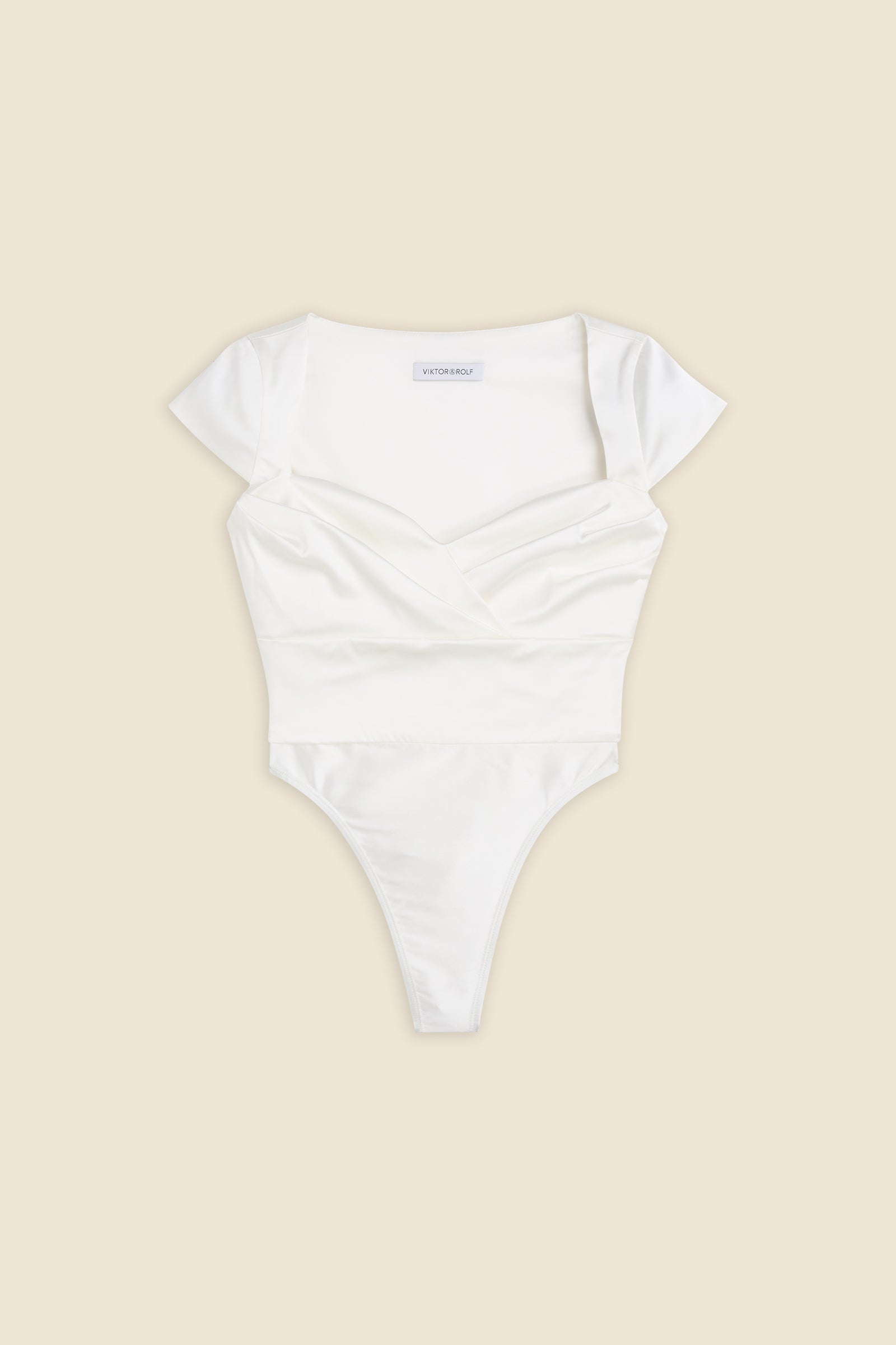 The meticulously placed pleats and stretch satin define the elegance of the body, reflecting classic haute couture craftsmanship with a modern edge