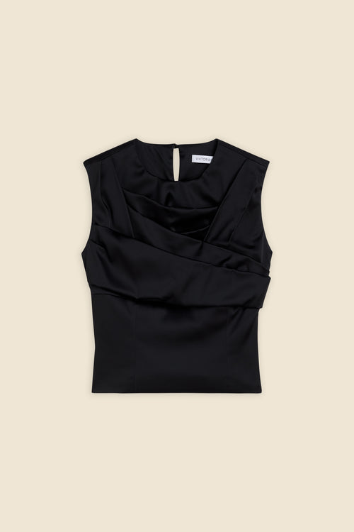 The meticulously placed pleats and stretch satin define the elegance of the top, reflecting classic haute couture craftsmanship with a modern edge